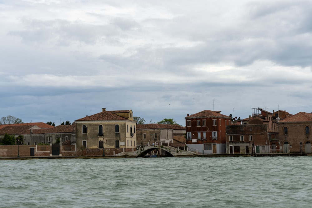 a large body of water with buildings in the background