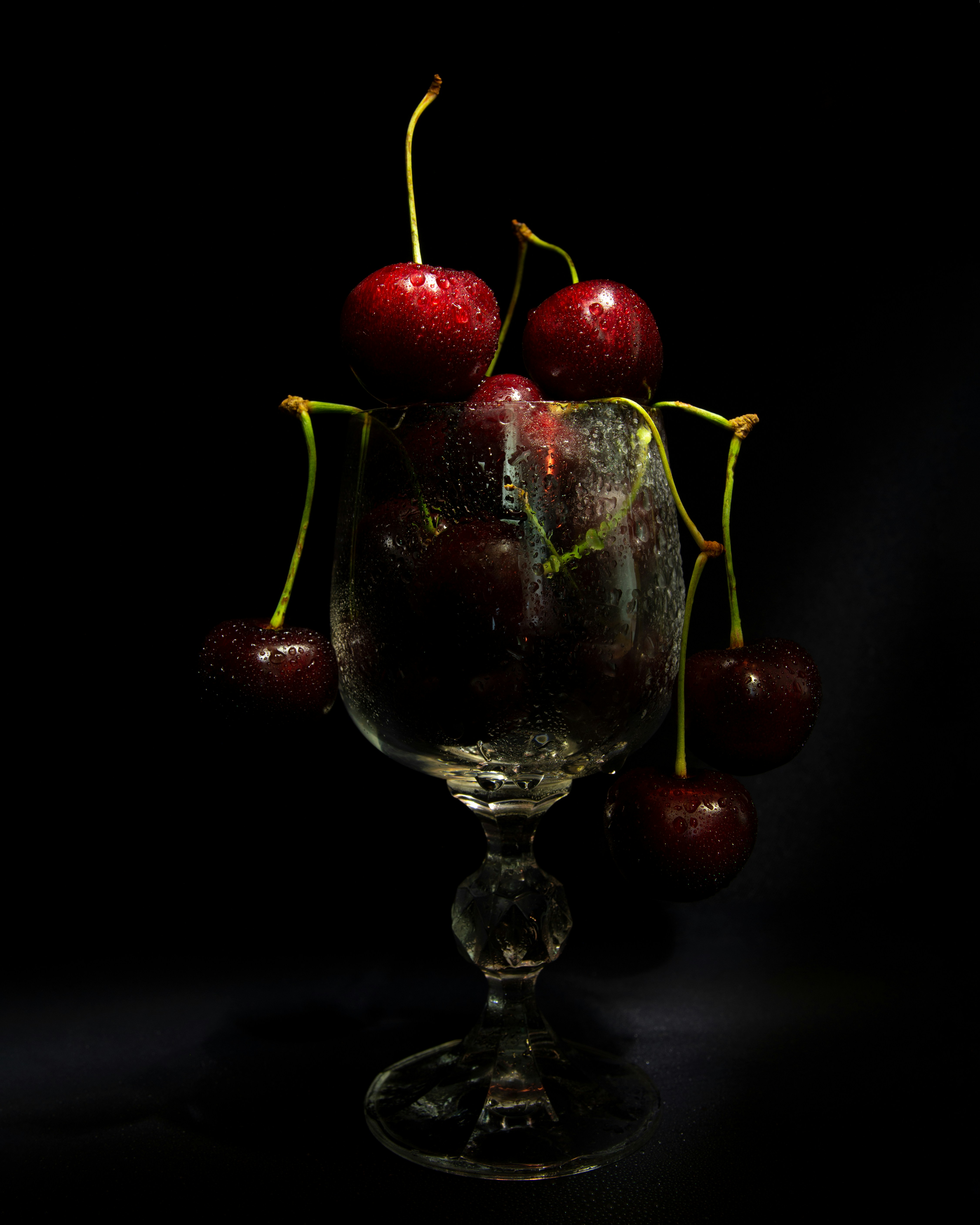 Assortment of whole fruits with a glass of water