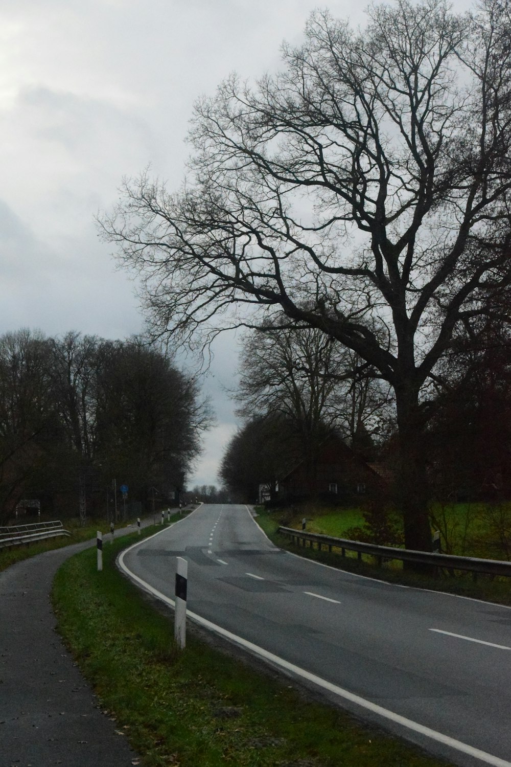 a curved road with a sign on the side of it