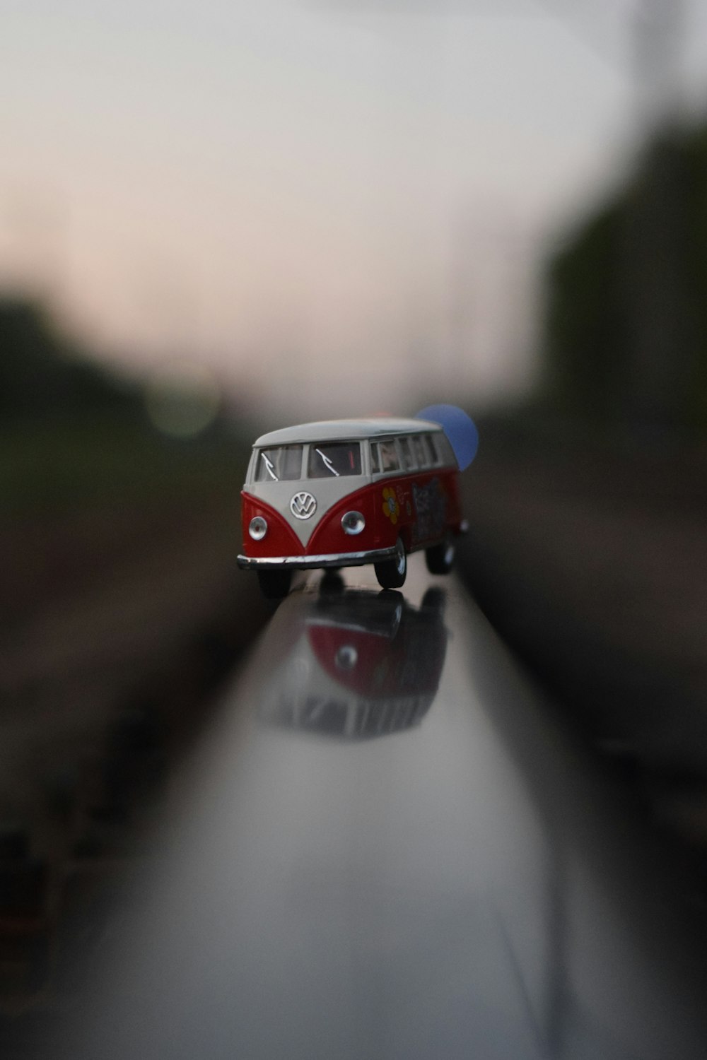 a toy bus is sitting on the side of the road