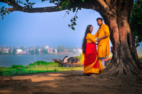 A couple exchanging vows with the sacred river Ganges softly flowing behind them.