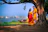 A smiling couple standing by the Ganges River at sunrise, with ancient temples in the background.