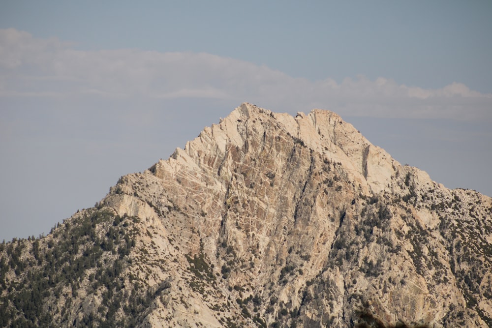 a very tall mountain with a sky in the background