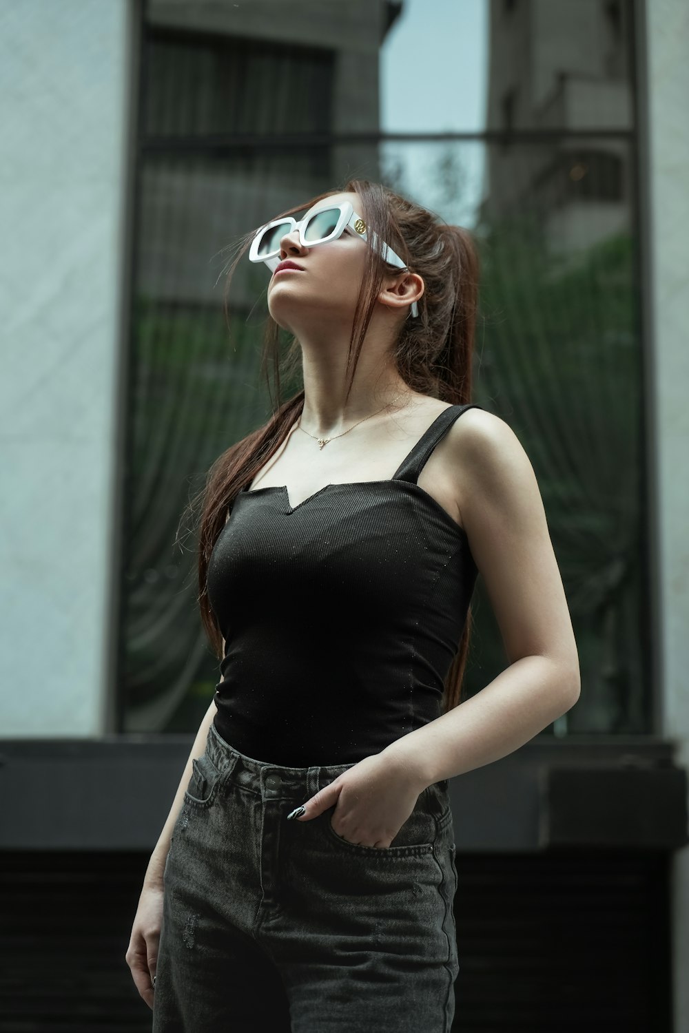 a woman wearing sunglasses and a black top