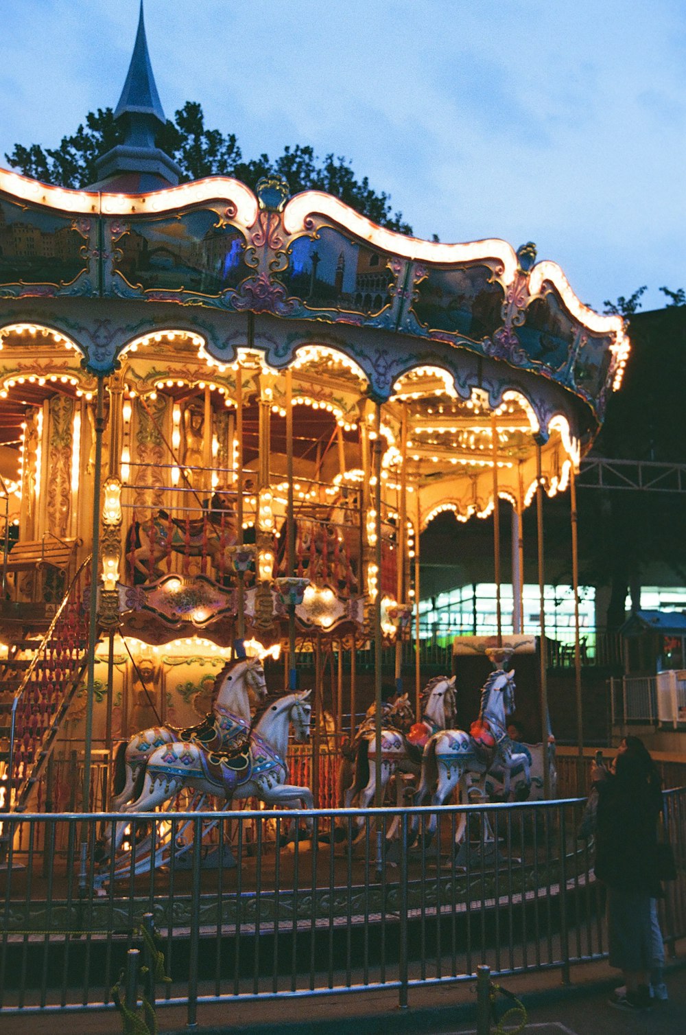 a merry go round is lit up at night