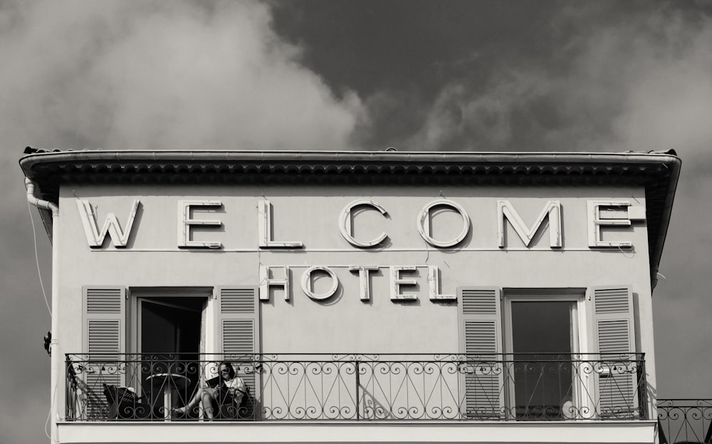 a black and white photo of a welcome hotel