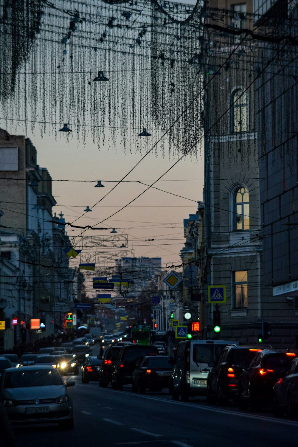 a street filled with lots of traffic next to tall buildings