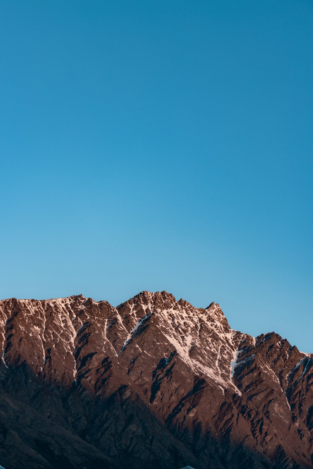 a plane flying over a snow covered mountain range