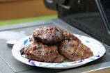 A tray of freshly grilled hickory smoked burgers lined up ready to serve.
