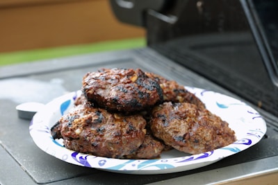 A tray of freshly grilled hickory smoked burgers lined up ready to serve.