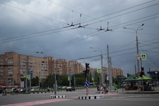 Wide shot of a busy street with several LED traffic lights and luminarias installed by High Solutions.