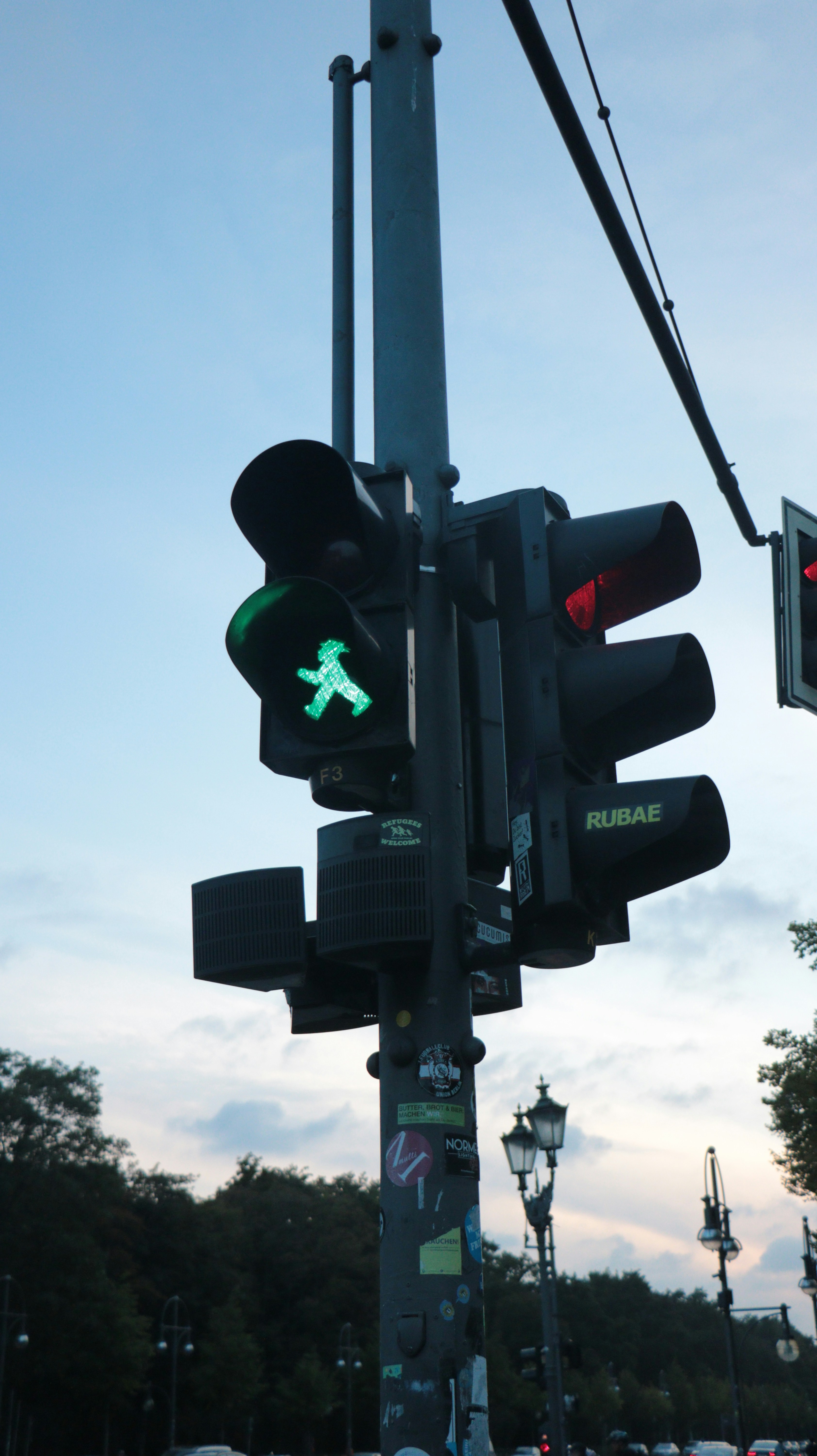 a traffic light with a green pedestrian crossing signal