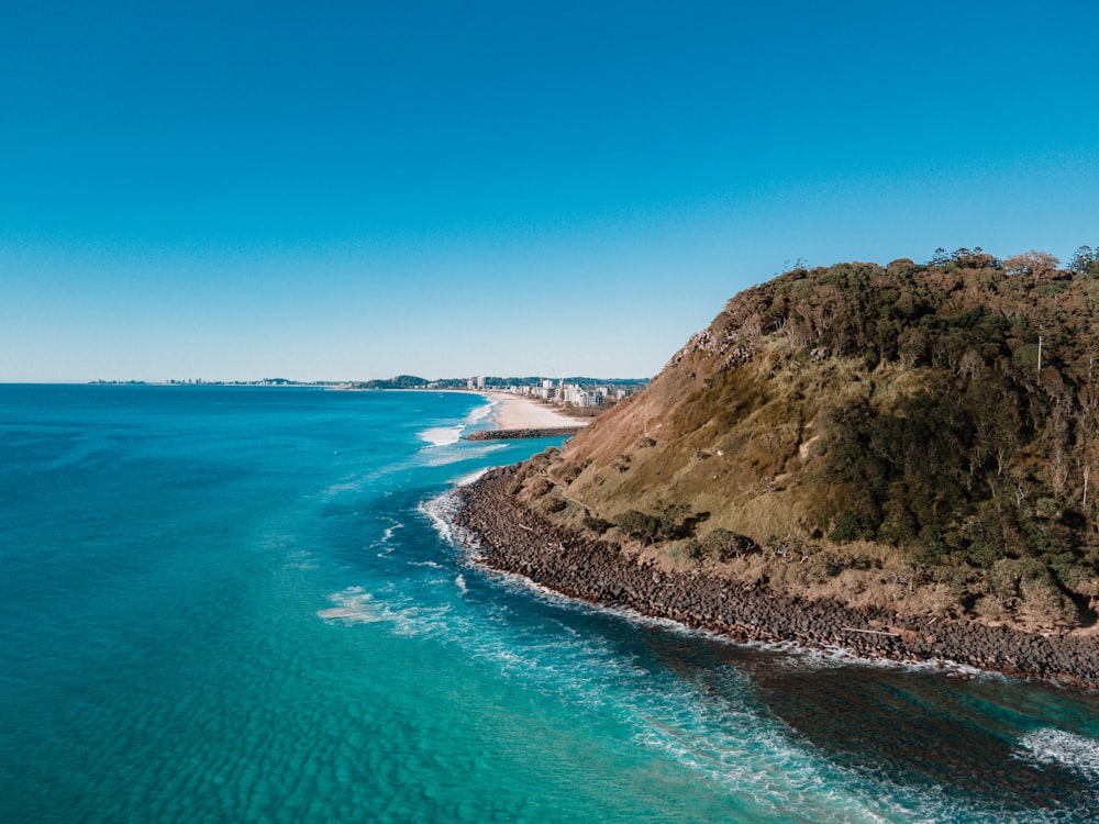 a large body of water next to a cliff