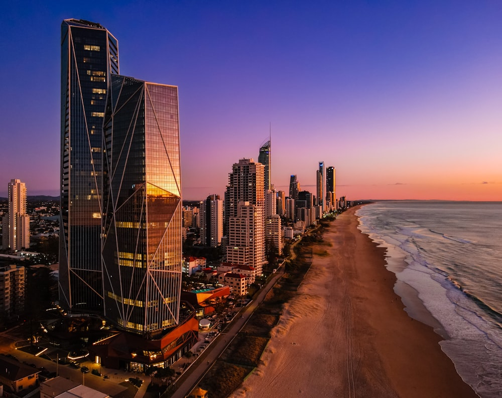a view of a beach and a city at sunset