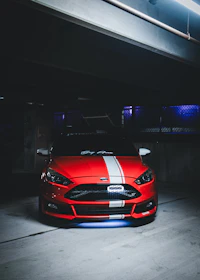 A freshly restored car gleaming under bright garage lights, ready to hit the road.