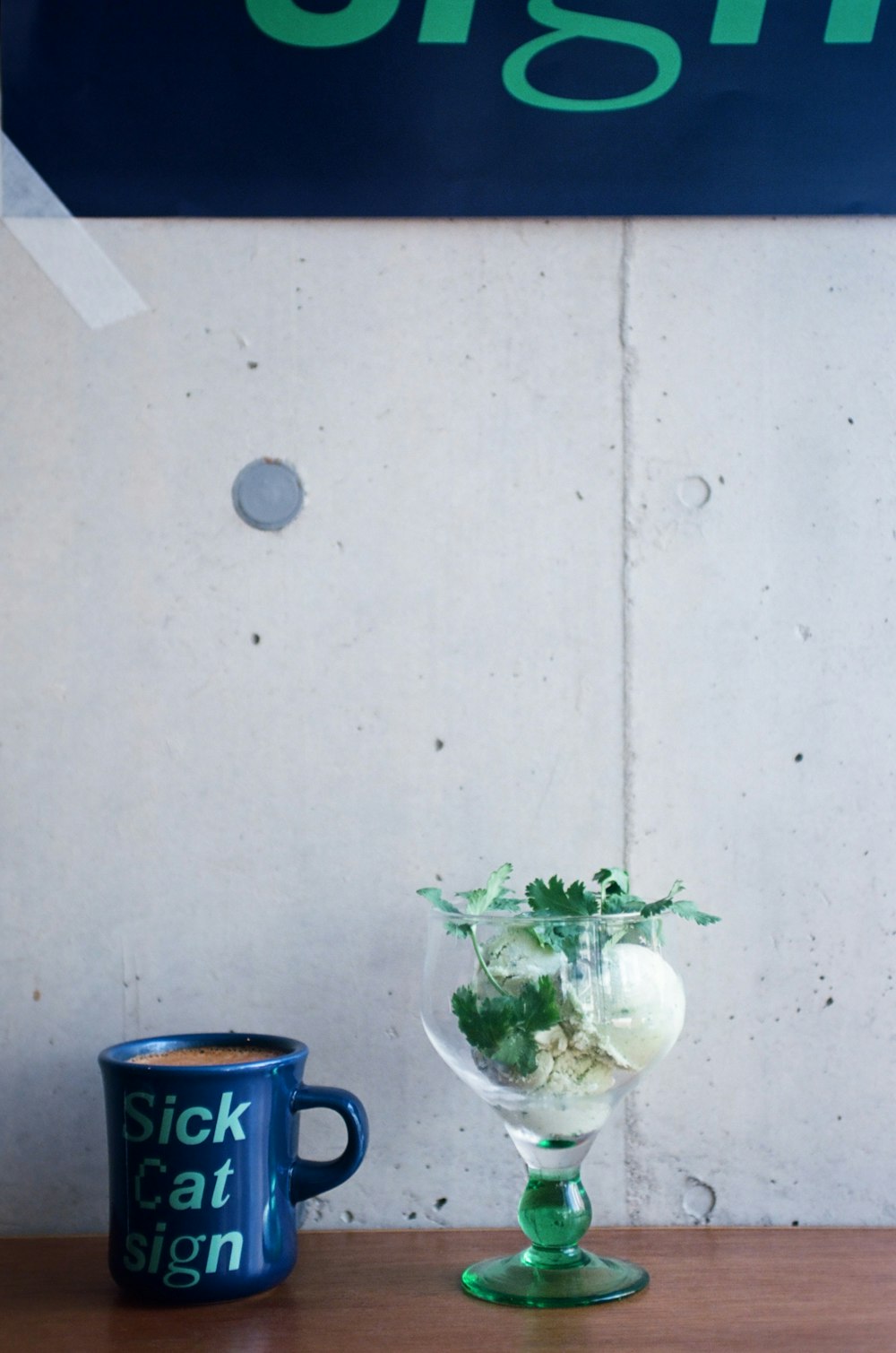 a table with a mug and a sign on it