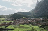 A picturesque village nestled among lush green hills and mountains.