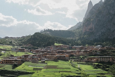 A picturesque village nestled among lush green hills and mountains.