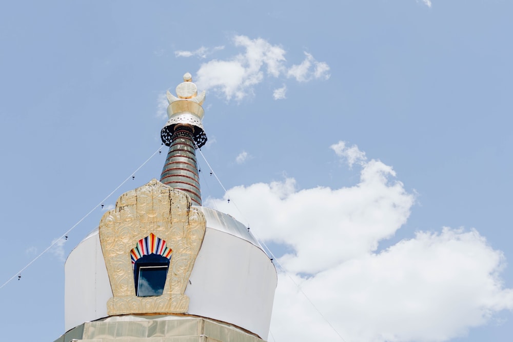 a very tall tower with a clock on it's side