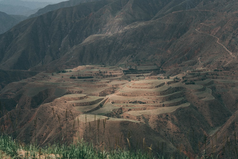 a view of a mountain range with a valley in the background