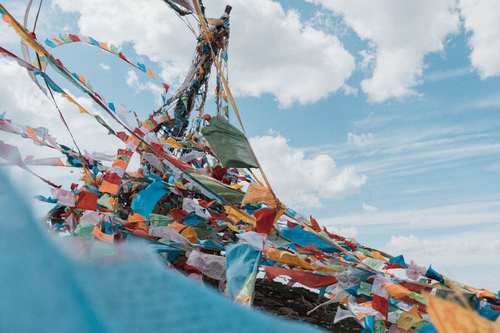 a bunch of colorful flags hanging from the side of a boat