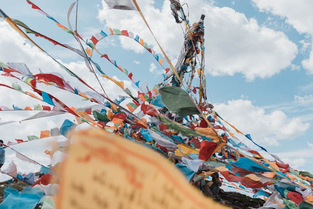 a bunch of colorful flags flying in the sky