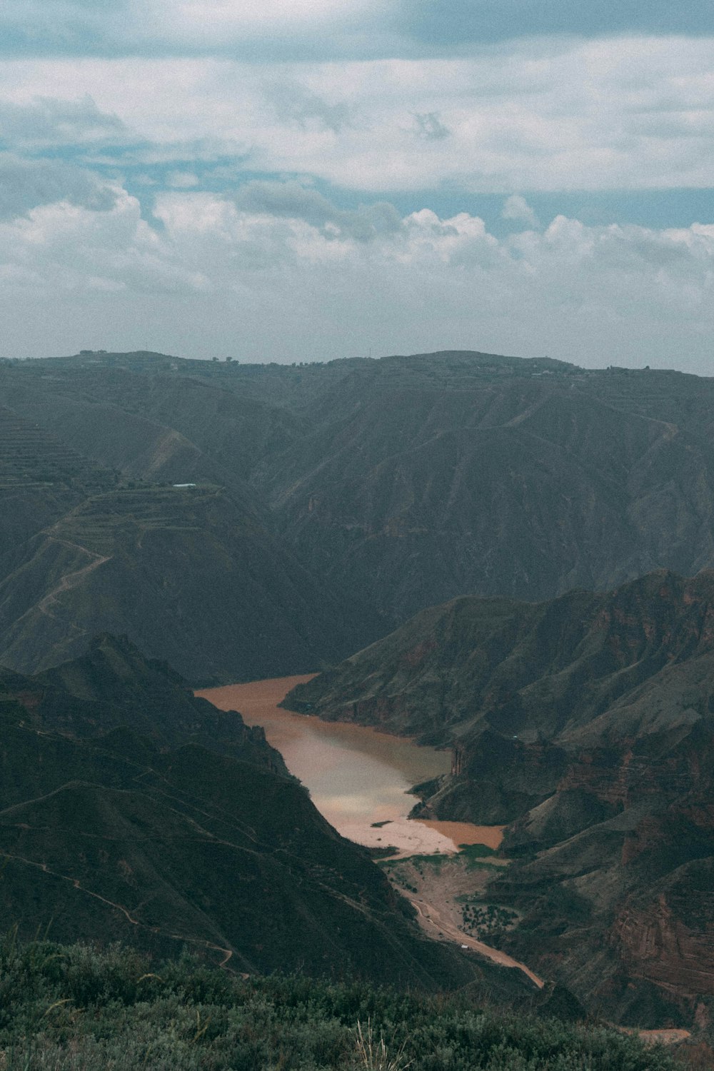 a view of a valley with a river running through it