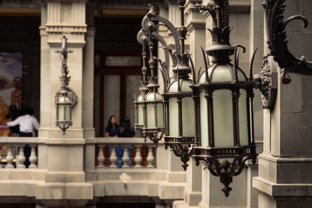 a couple of lights hanging from the side of a building