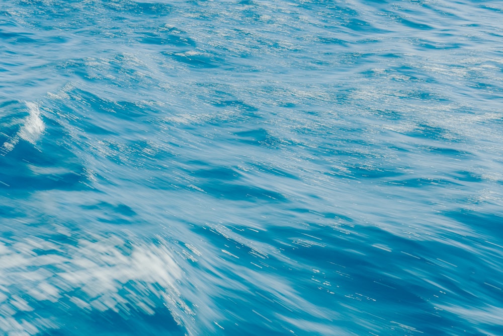 a person riding a surfboard on a wave in the ocean