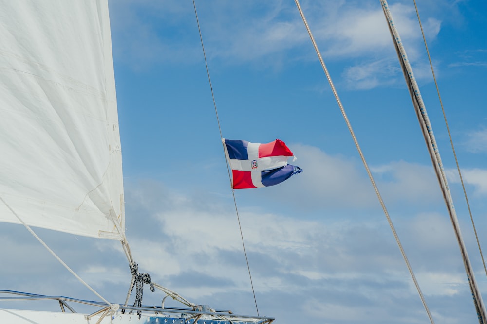 a flag flying on a sailboat in the ocean