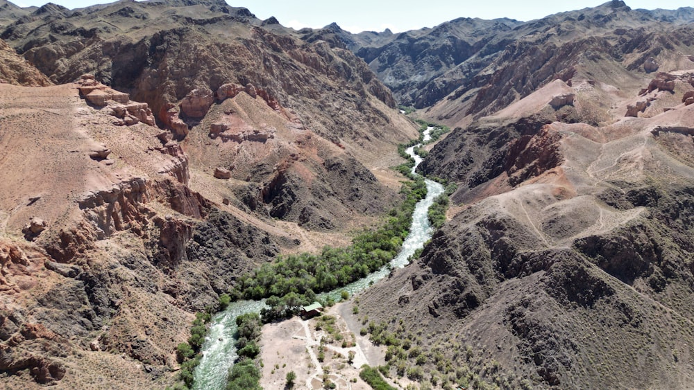 a river running through a canyon surrounded by mountains