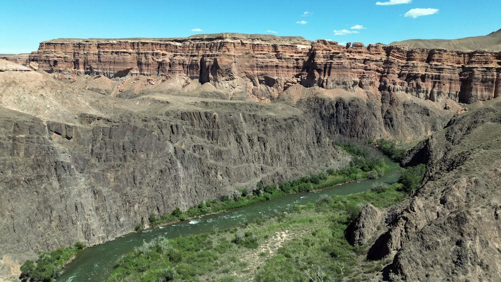 a river running through a canyon surrounded by mountains