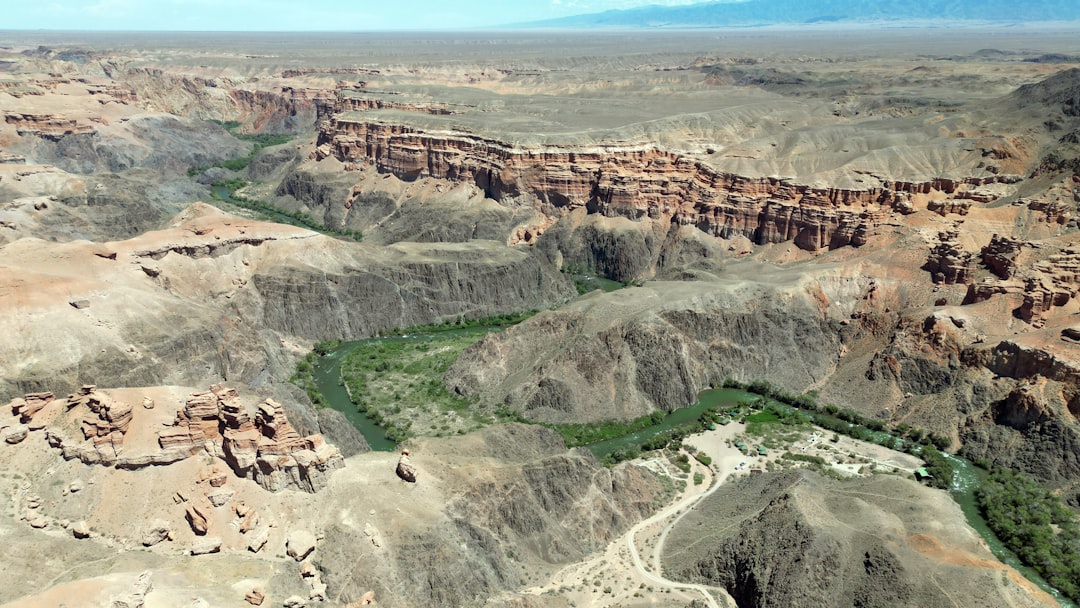 an aerial view of a canyon with a river running through it,