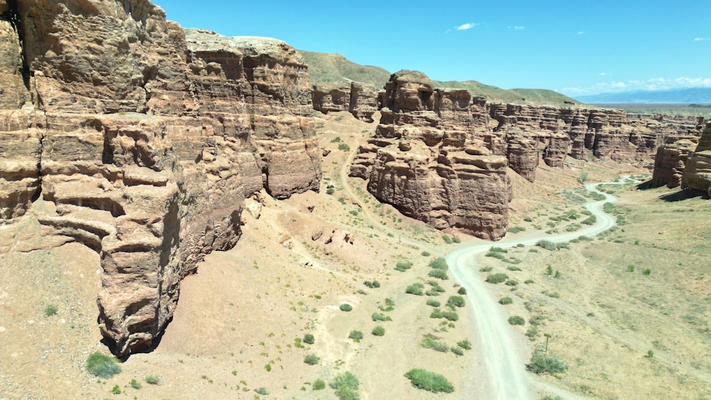 an aerial view of a dirt road in the desert