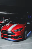 A fully detailed sports car with a vibrant custom wrap shining under garage lights.