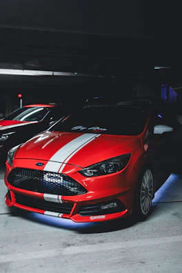 A fully detailed sports car with a vibrant custom wrap shining under garage lights.