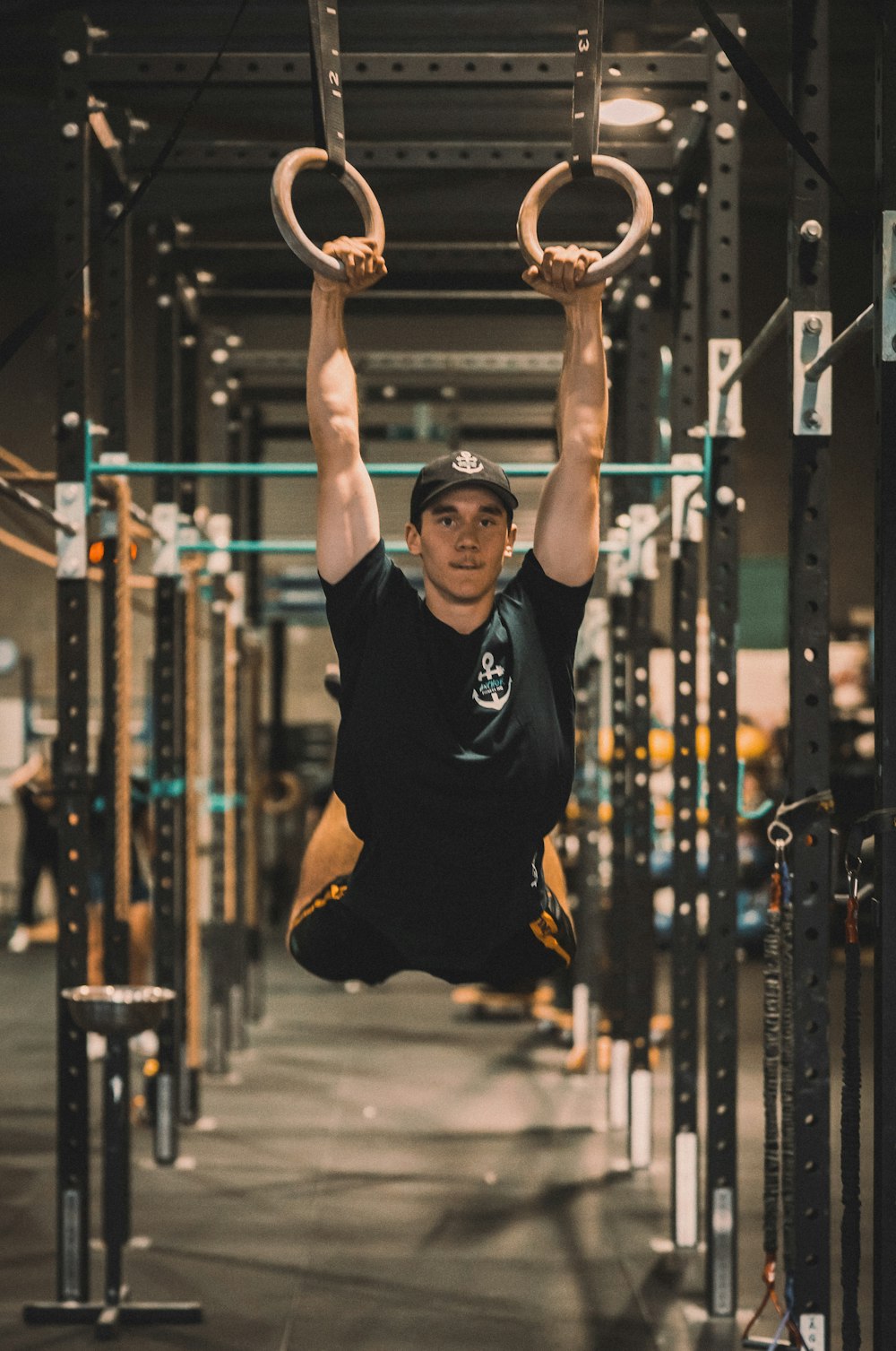 a man hanging upside down in a gym