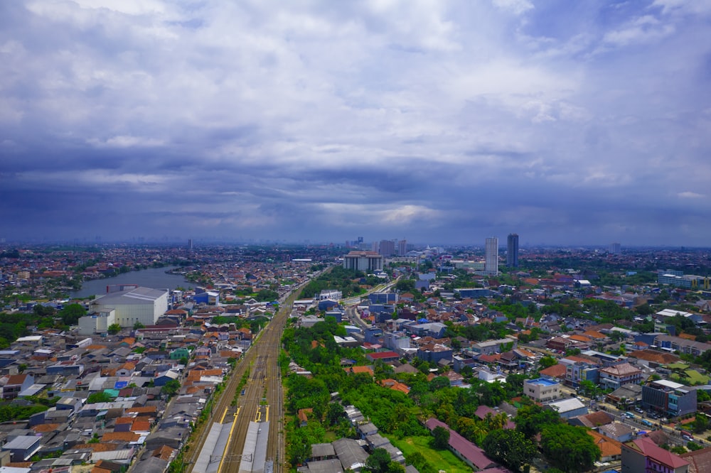 an aerial view of a city with a cloudy sky