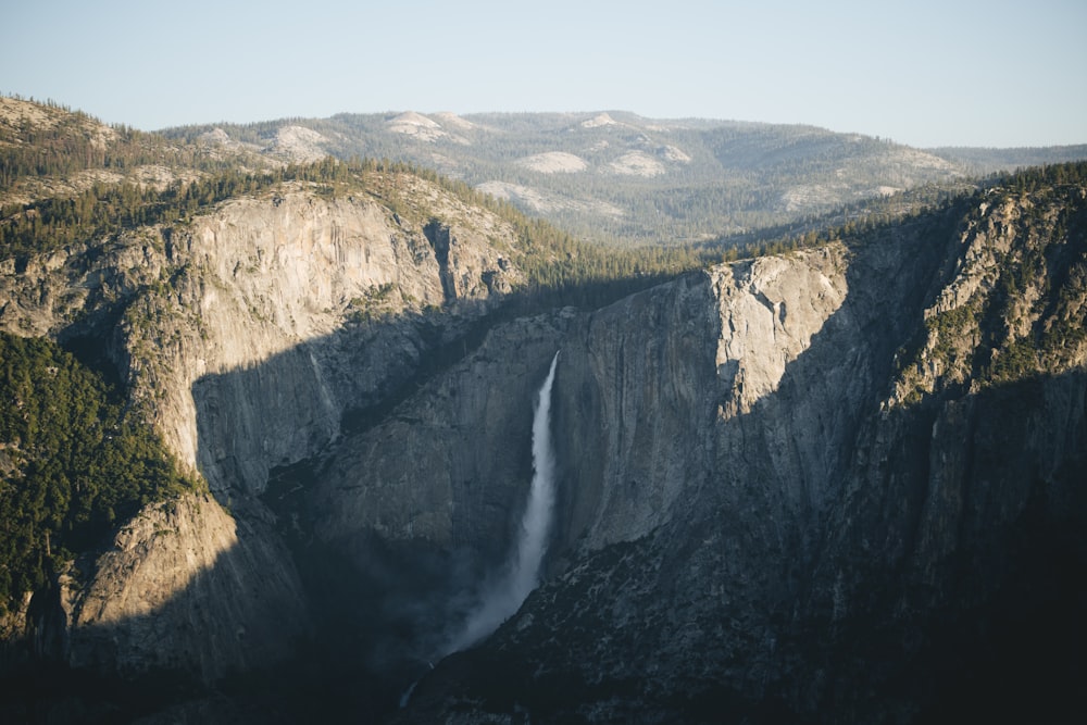 a view of a waterfall in the mountains