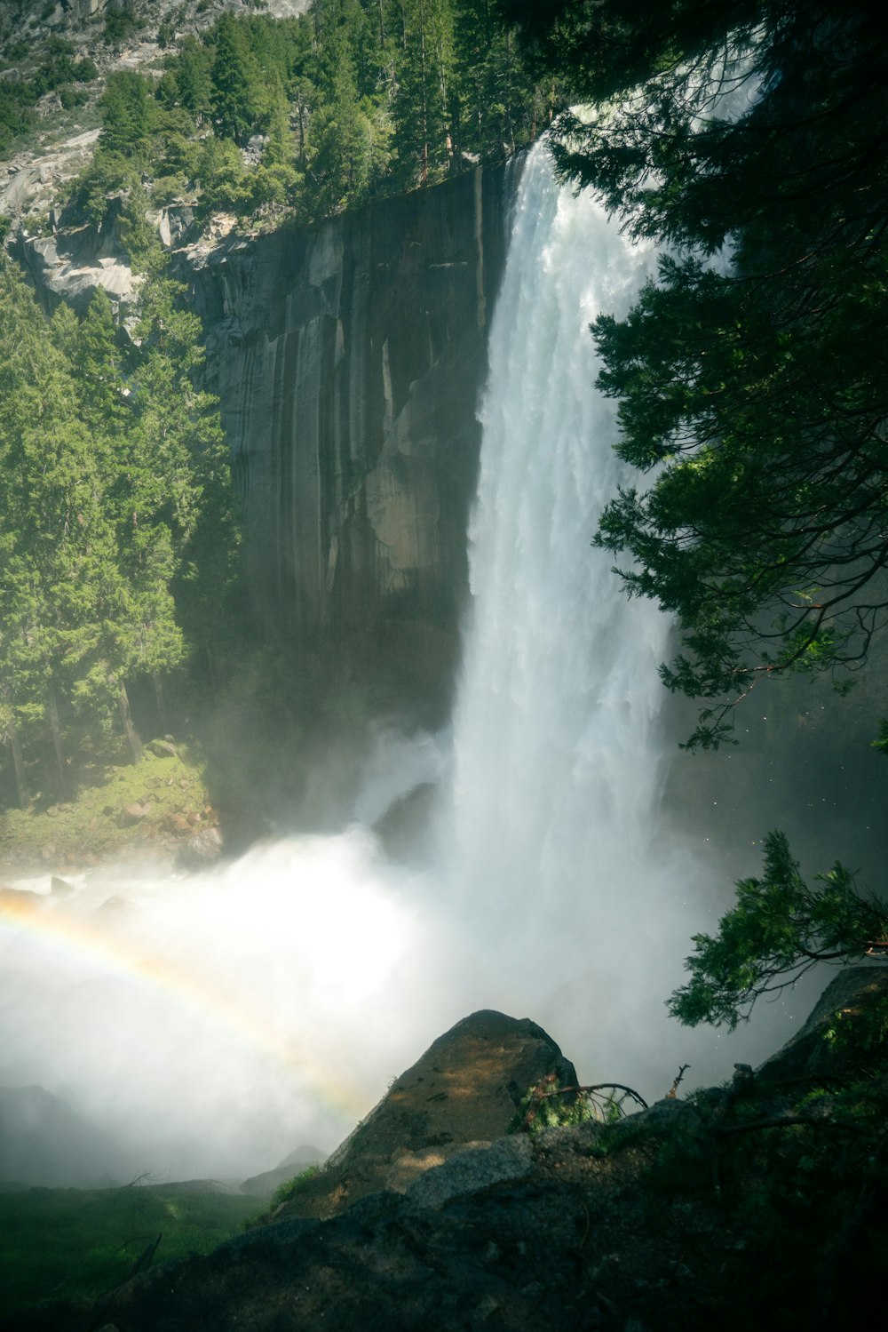 a waterfall with a rainbow in the middle of it