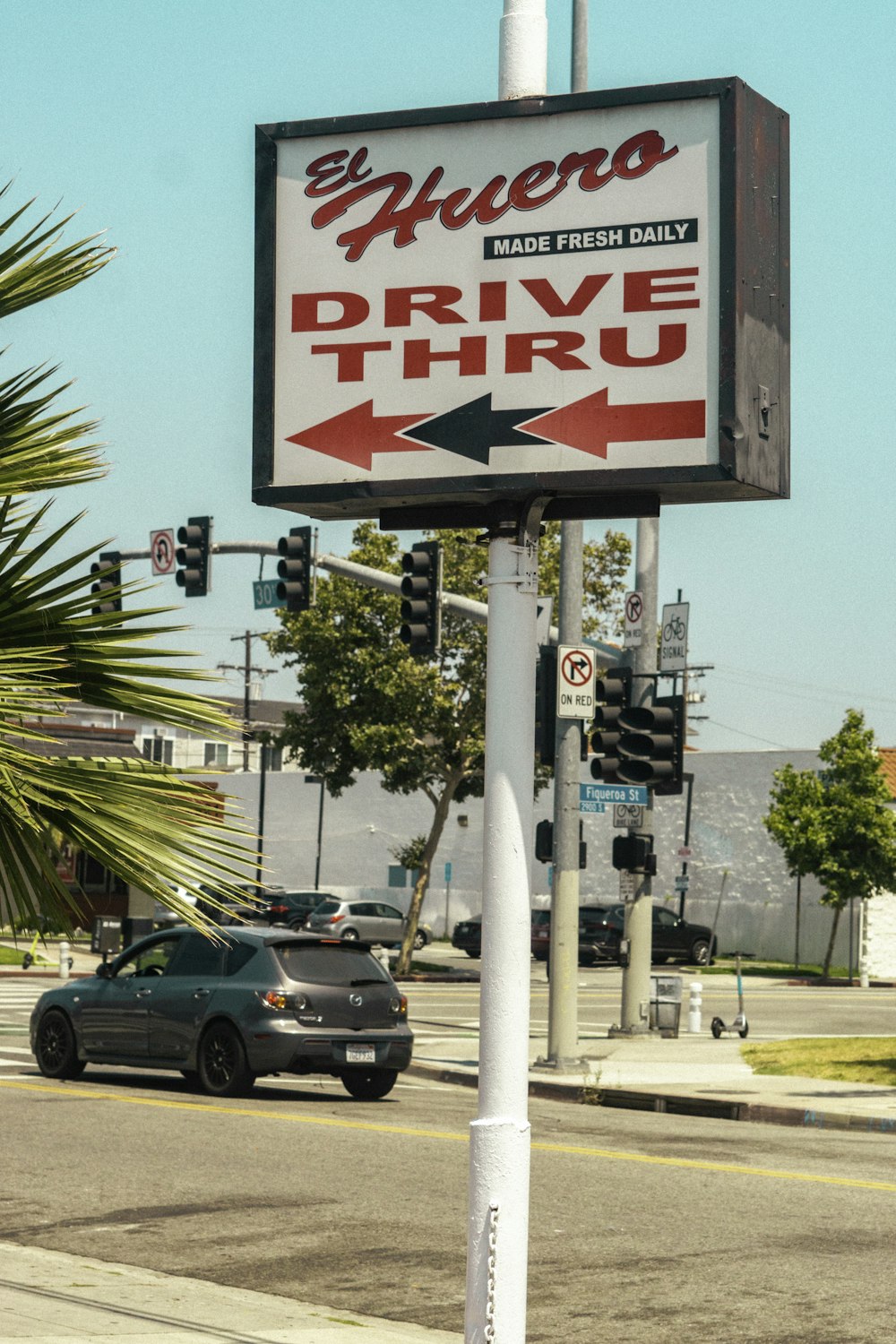 a drive thru sign on the side of the road