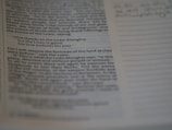 A close-up of a page from a book or Bible, highlighted with a specific verse stating gratitude to the Lord. The text is clear but the surrounding text is slightly out of focus.