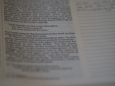 A close-up of a page from a book or Bible, highlighted with a specific verse stating gratitude to the Lord. The text is clear but the surrounding text is slightly out of focus.