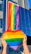 Close-up of hands holding a PridePulse package with a rainbow sticker.