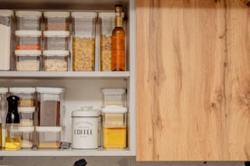 a kitchen cabinet filled with lots of food
