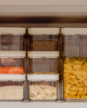a shelf filled with plastic containers filled with food