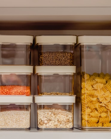 a shelf filled with plastic containers filled with food