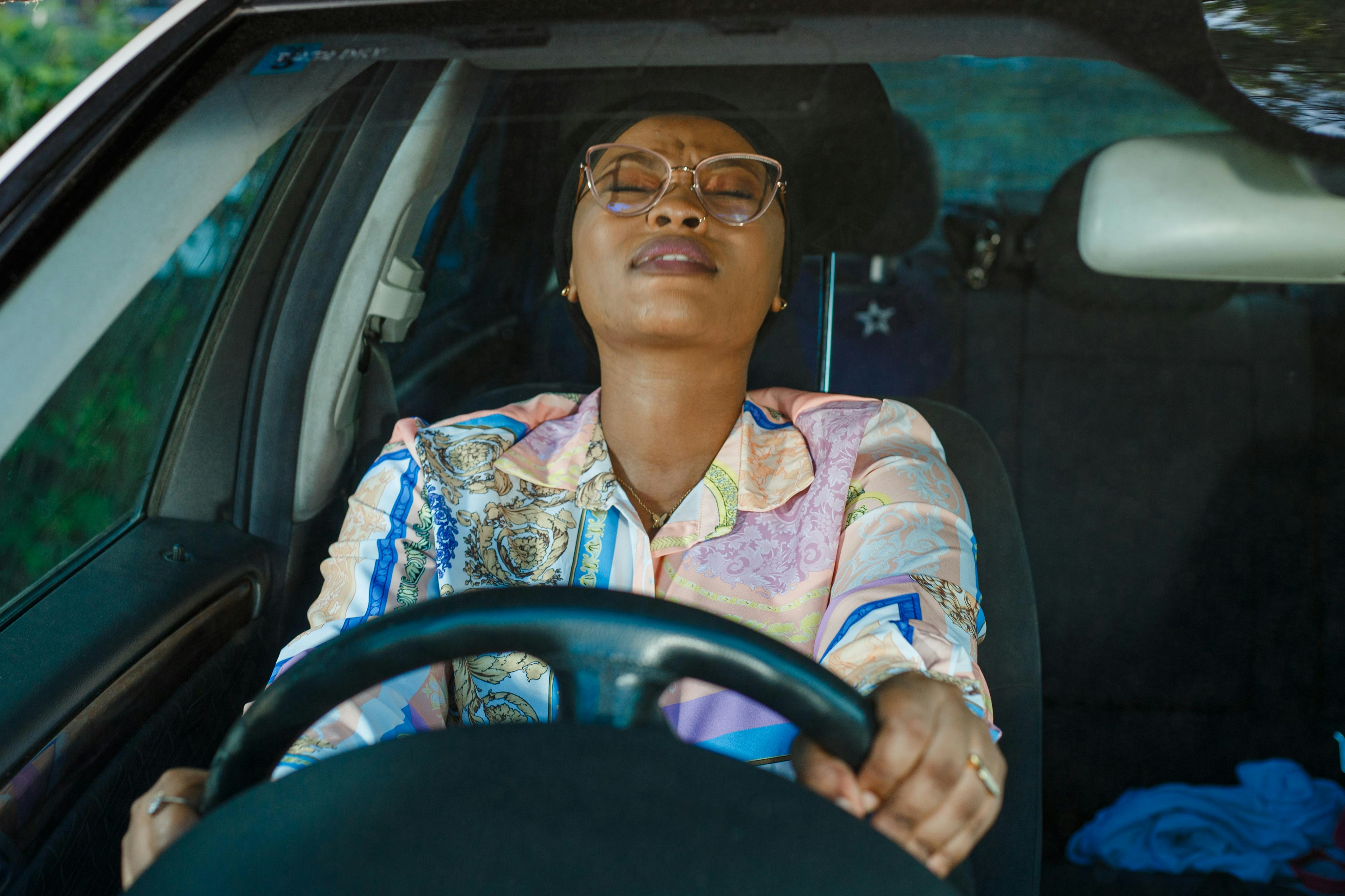 a woman sitting in the driver seat of a car