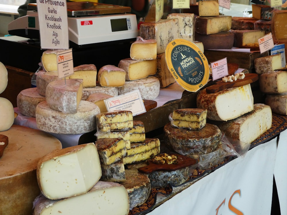 a variety of cheeses on display at a market
