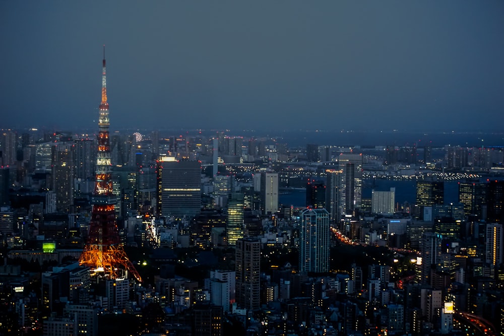 a view of a city at night from the top of a skyscraper